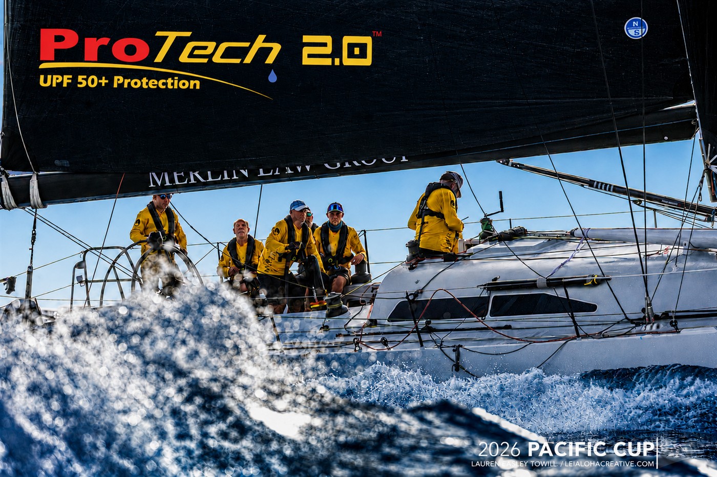 Merlin crew wearing yellow Pro-Tech 2.0 apparel during the 2026 Pacific Cup; photograph credited to Lauren Easley Towill